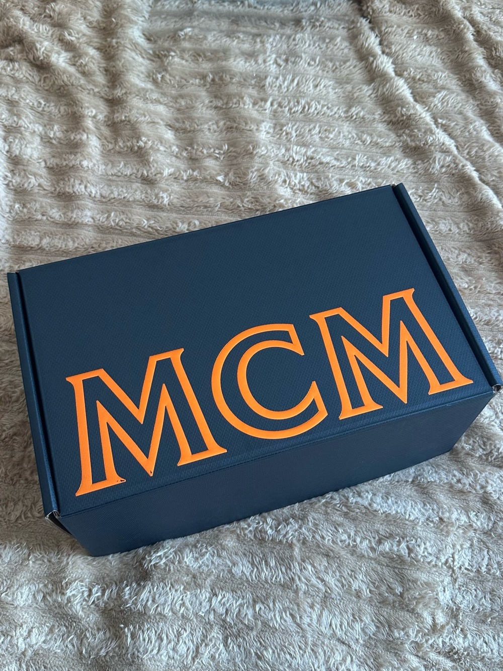 MCM Black Box Logo with Orange Logo